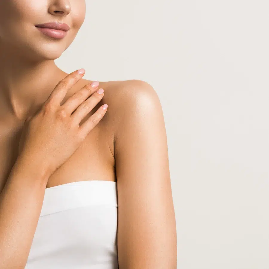 Femme touchant son épaule